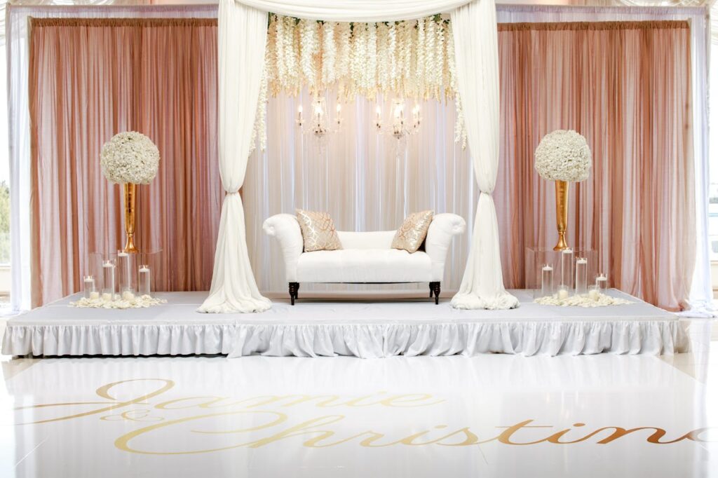 pexels-photo-2306286 A beautifully styled wedding stage featuring white furniture and floral decorations.